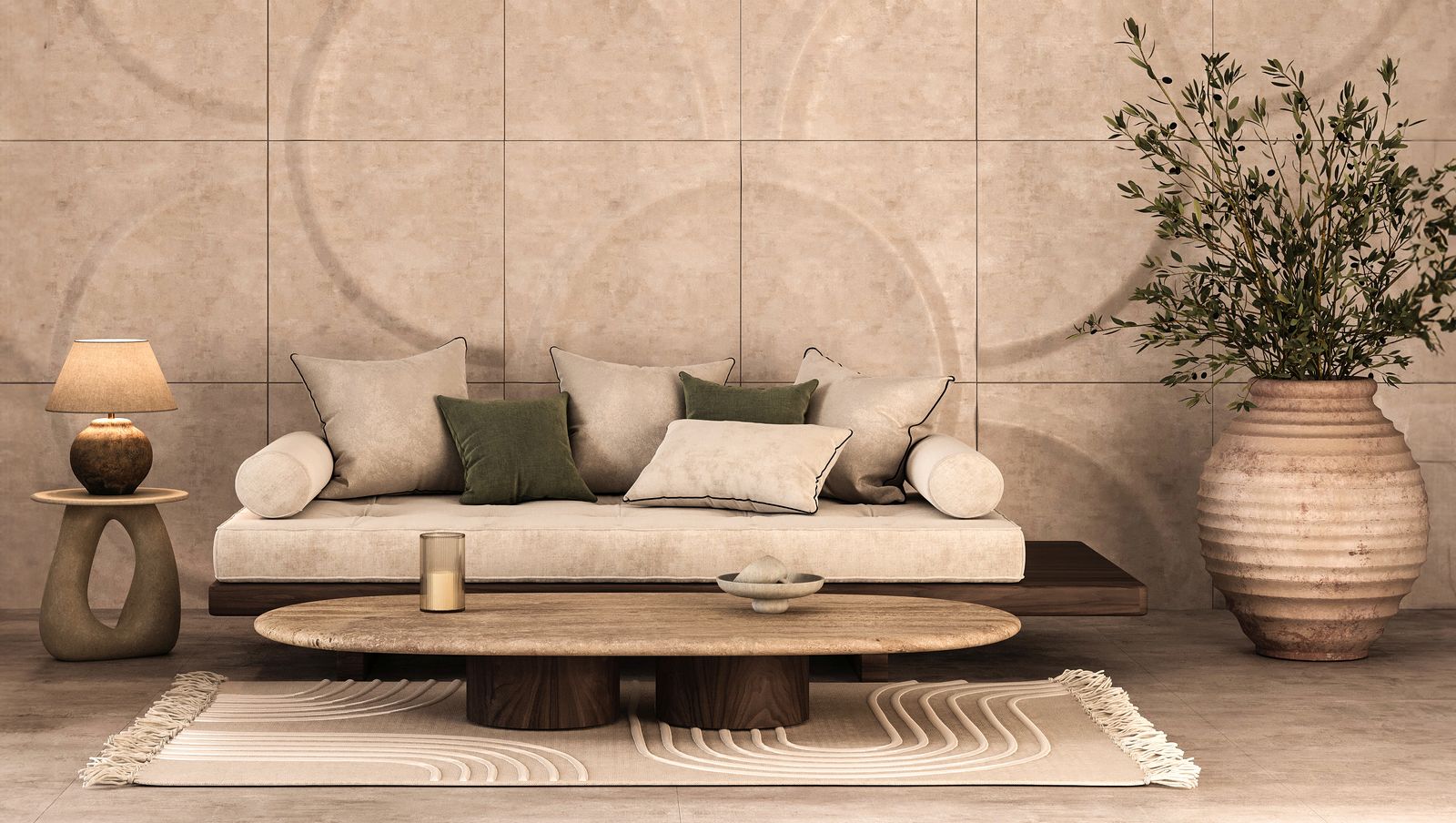 An organic modern living room with a low cream daybed with olive pillows, an oval stone coffee table, a sculpted stone side table and a terracotta urn of olive branches against a curved stone-textured wall